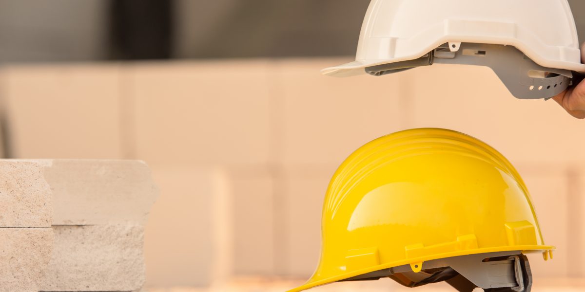 Hard hat on site construction background, Helmet safety, Labor day